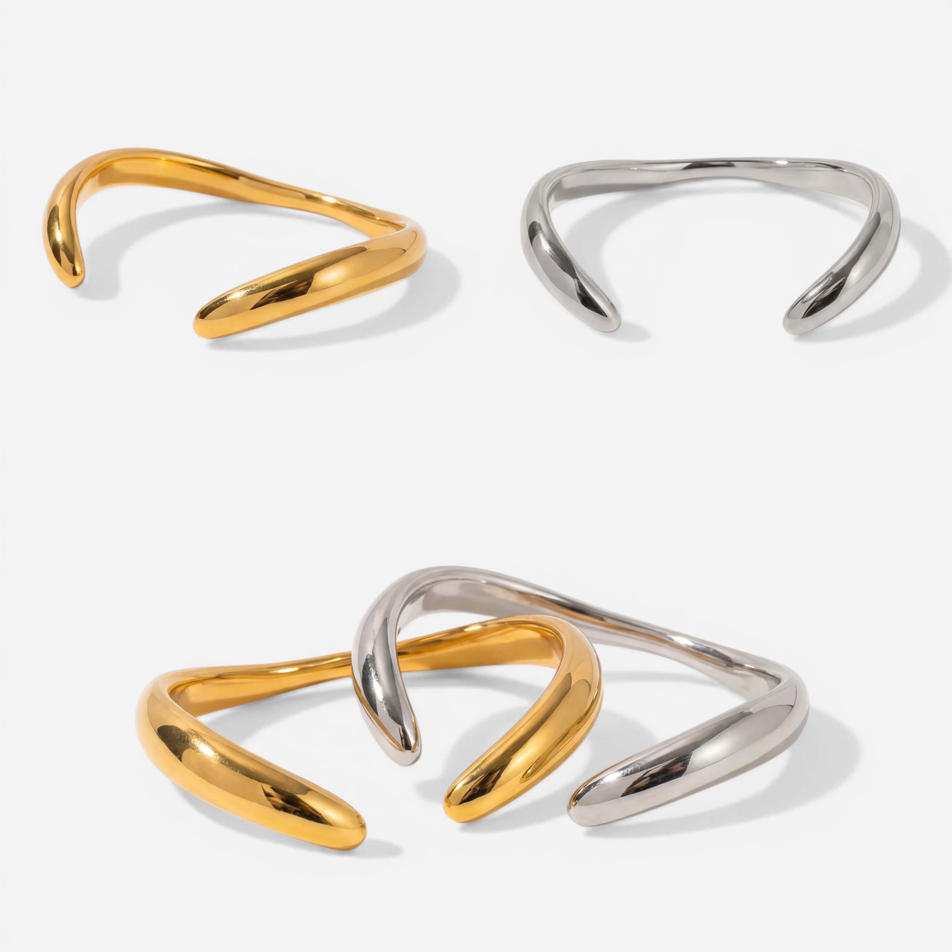 Aesthetic product photography of gold and silver liquid wave bangles on white background.
