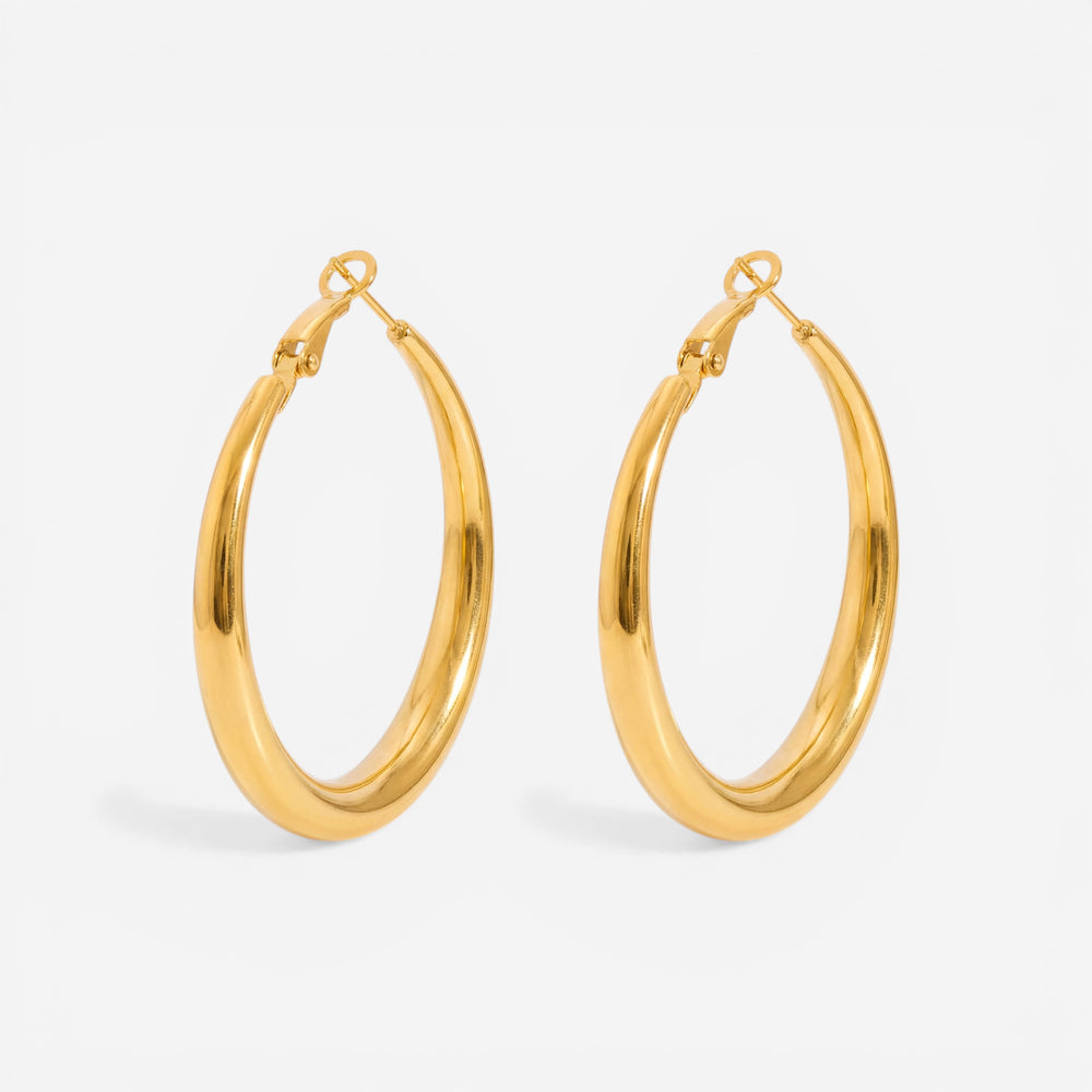 Medium thick gold hoop earrings minimalist everyday style.