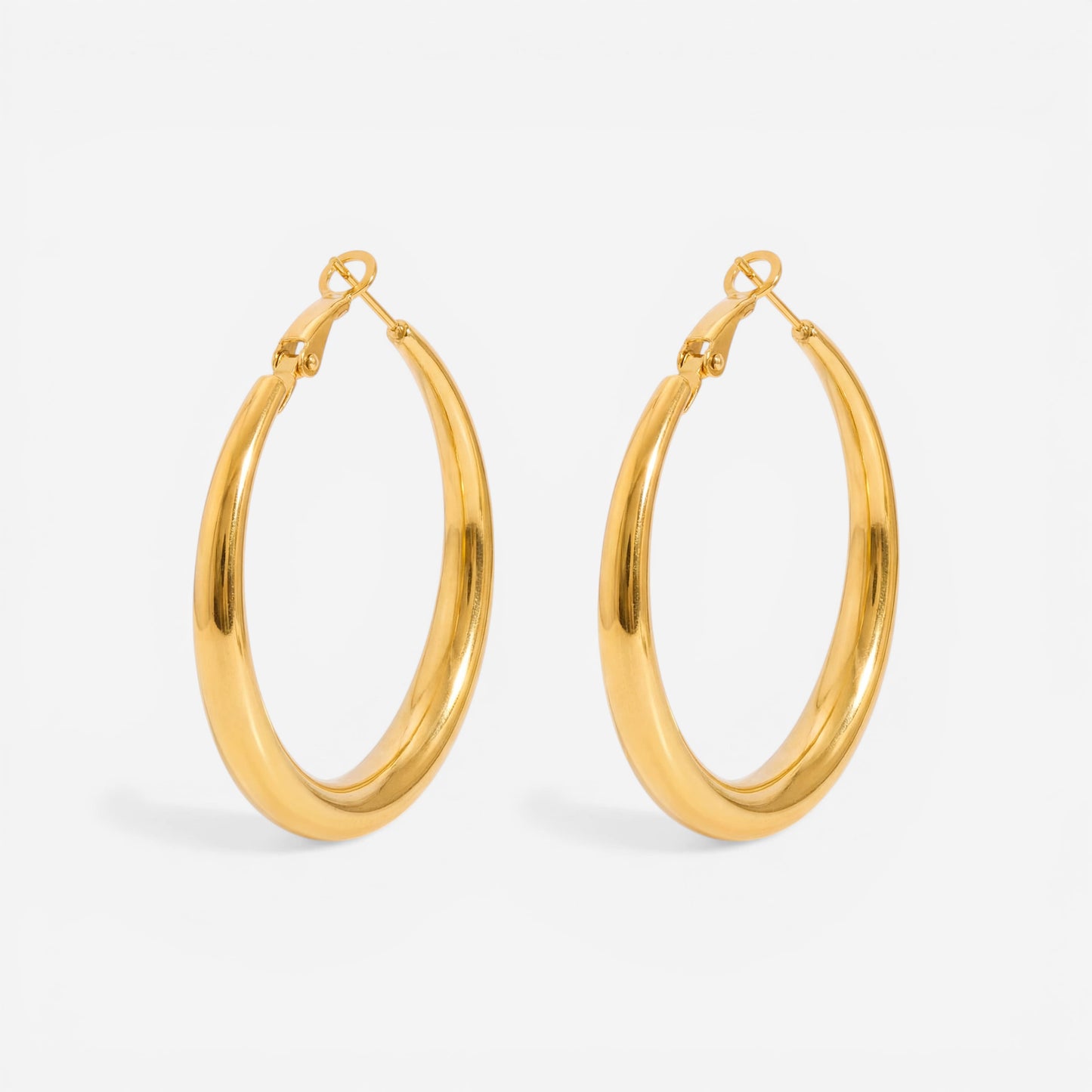 Medium thick gold hoop earrings minimalist everyday style.