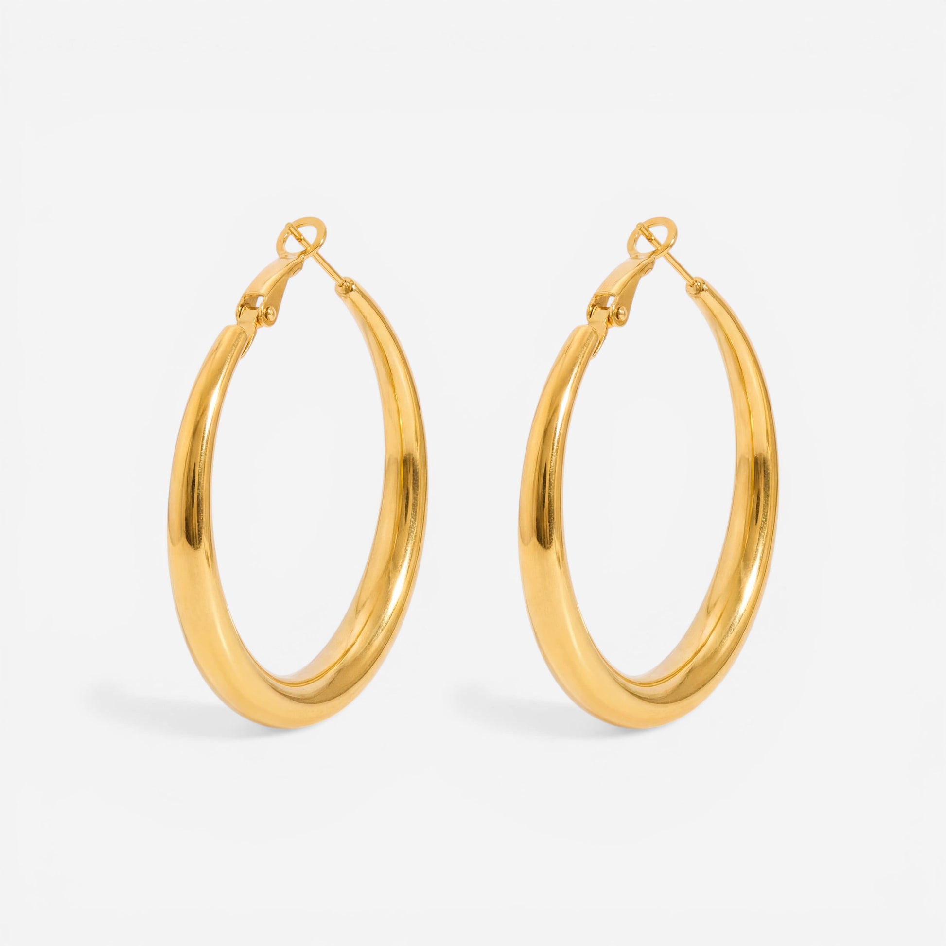 Medium thick gold hoop earrings minimalist everyday style.