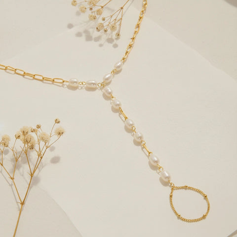 The complete Nereid Hand Chain displayed to show both the adjustable wrist bracelet and the delicate finger loop, illustrating its unique structure.