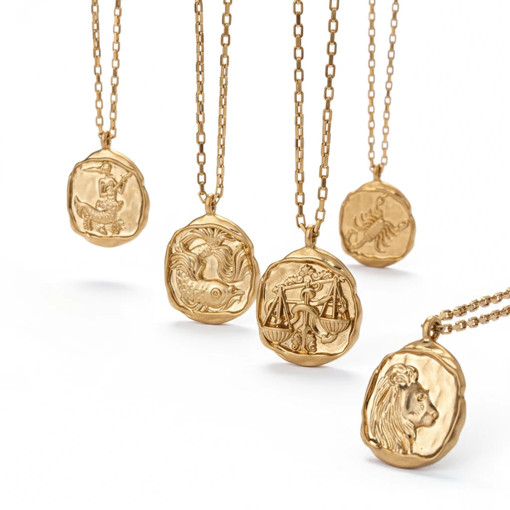 Collection of organic wax seal zodiac necklaces with matte gold finish and luxury box chains. Main image