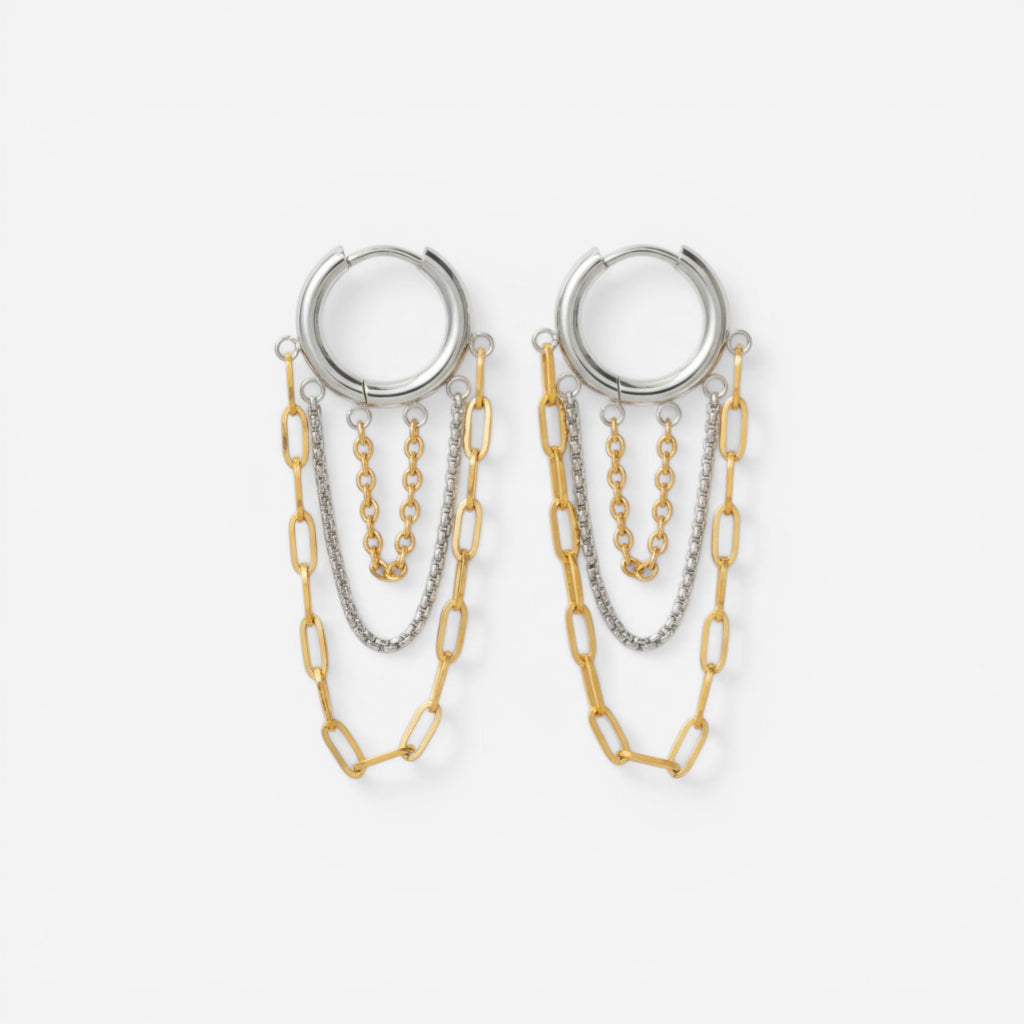 Mixed metal two-tone hoop earrings with silver and gold dangling chains.