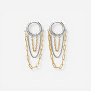 Mixed metal two-tone hoop earrings with silver and gold dangling chains.