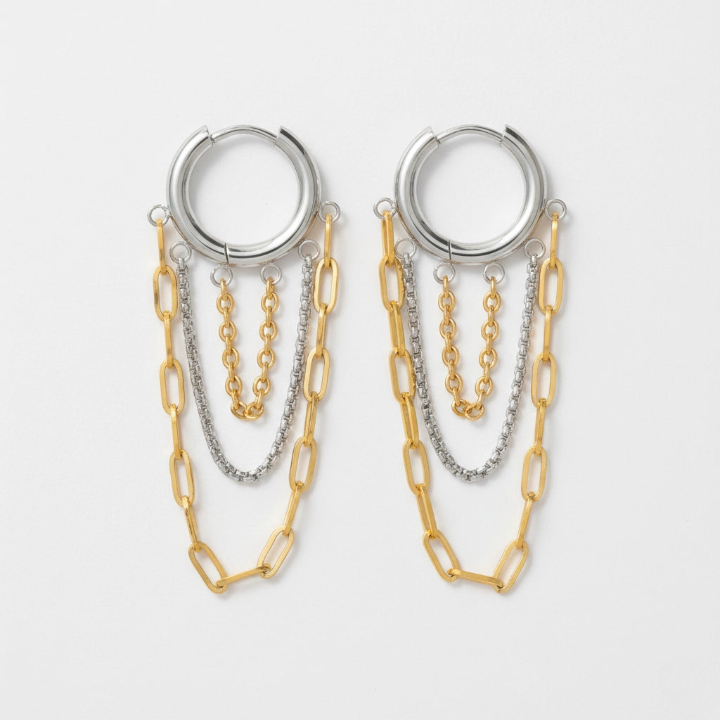 Mixed metal two-tone hoop earrings with silver and gold dangling chains.