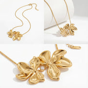 Aesthetic product photography of textured gold flower necklace details on white background.