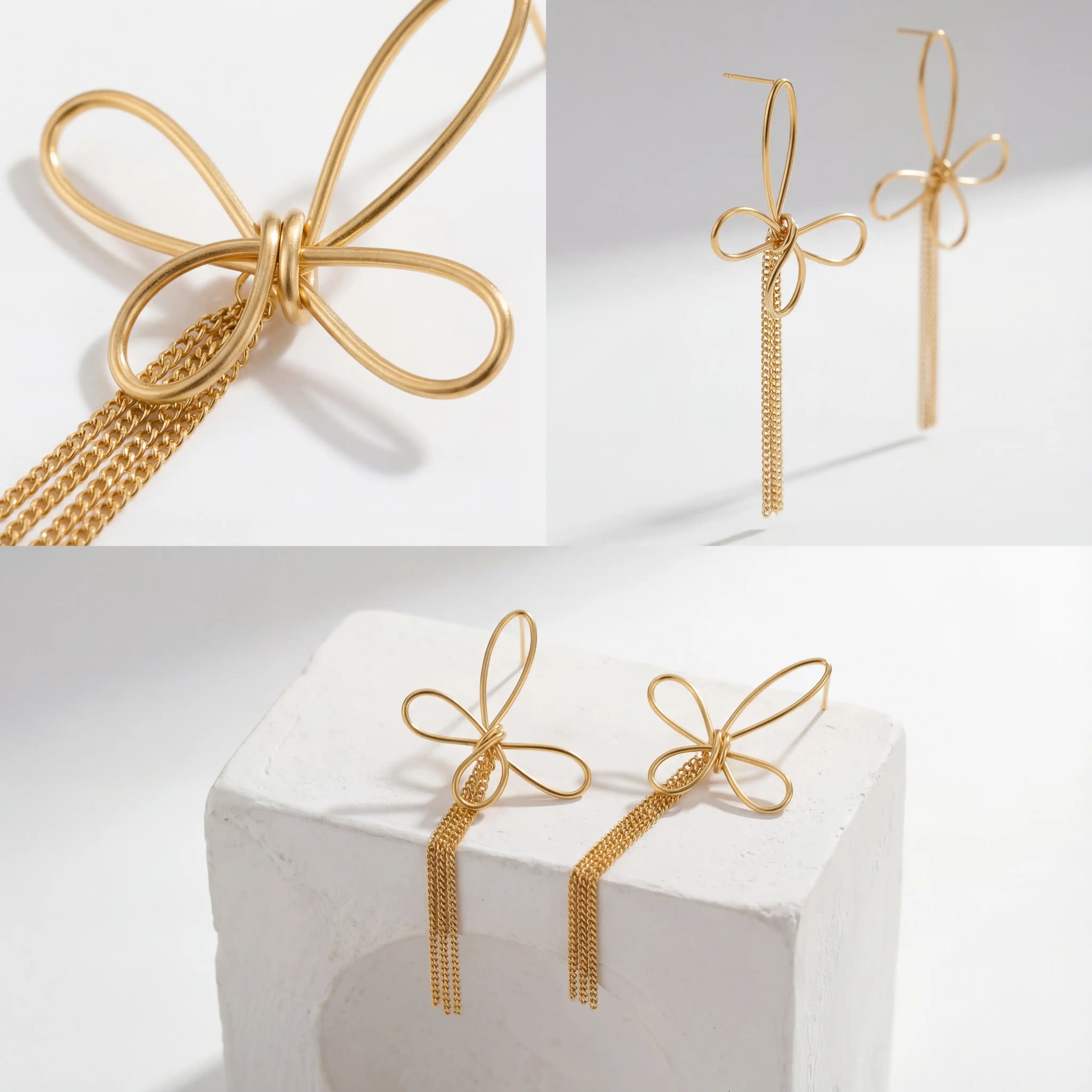 Aesthetic product photography details of gold wire bow earrings with tassel chains on white stone.