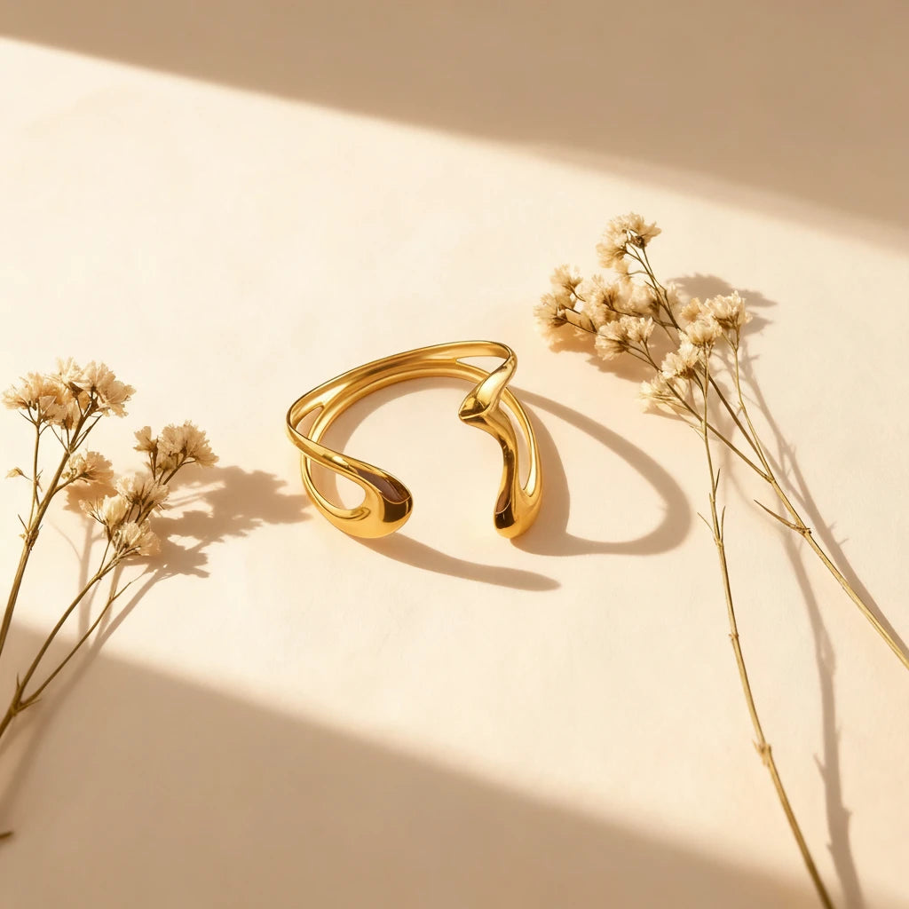 An artistic shot of The Pythia Cuff in warm sunlight, emphasizing its powerful, minimalist aesthetic and brilliant tarnish-proof shine.