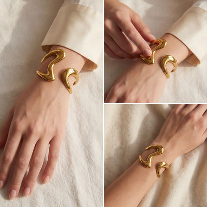 Lifestyle photography of woman wearing bold gold cuff bracelet artistic jewelry style.