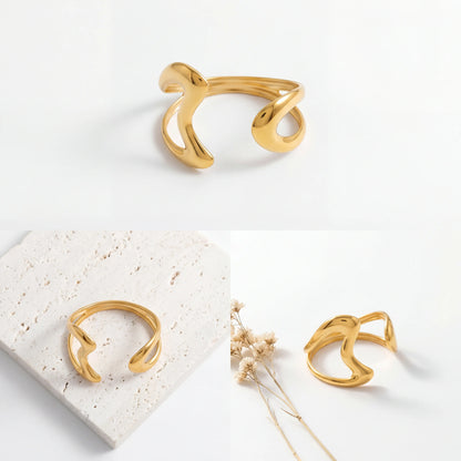 Aesthetic product photography of liquid metal gold cuff bracelet on white stone background.