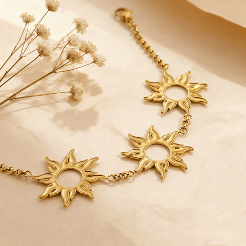 Luminova Radiant Sun Charm Bracelet with detailed sunburst pendant on a clean gold white background.