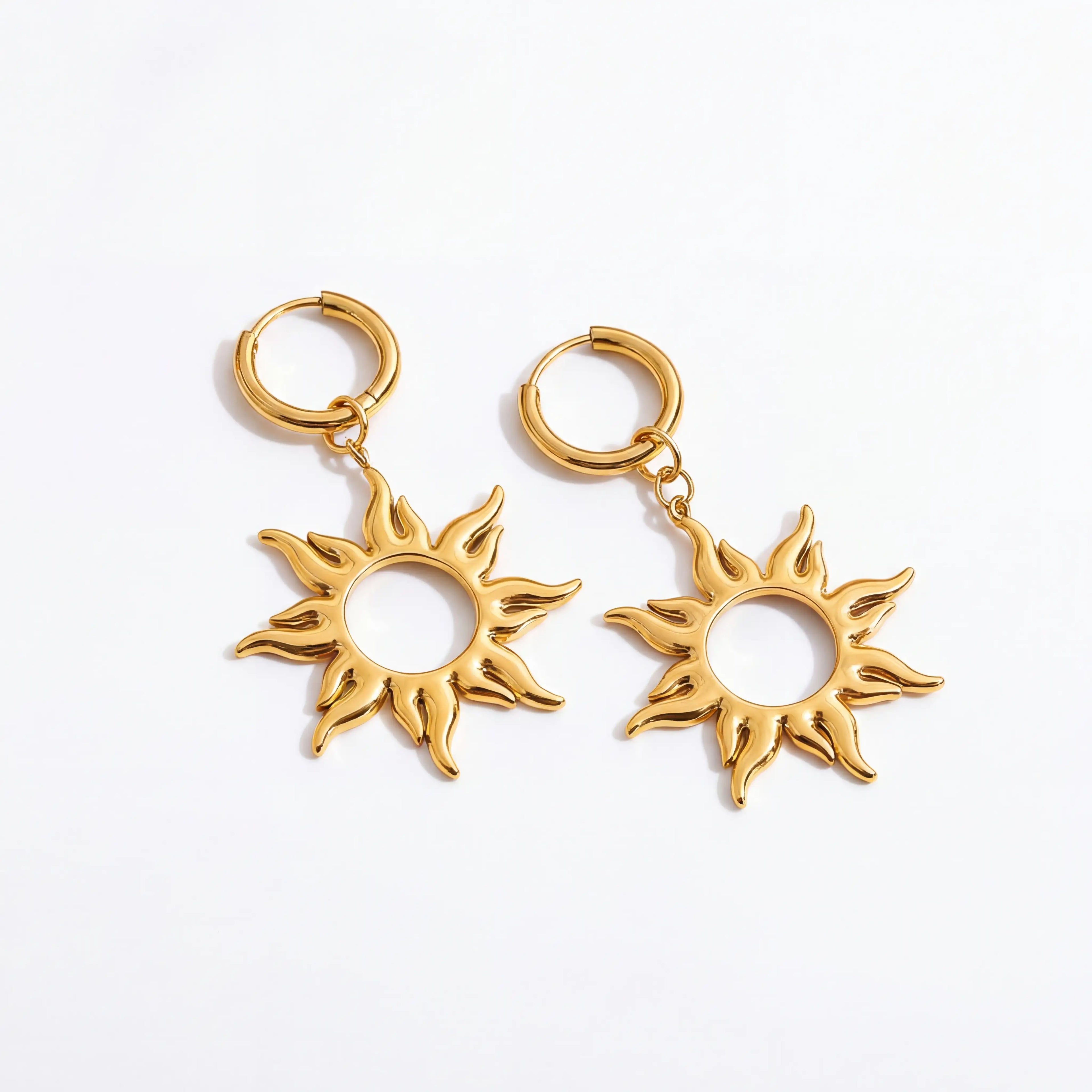 Pair of gold sunburst dangle earrings with huggie hoop waterproof stainless steel.