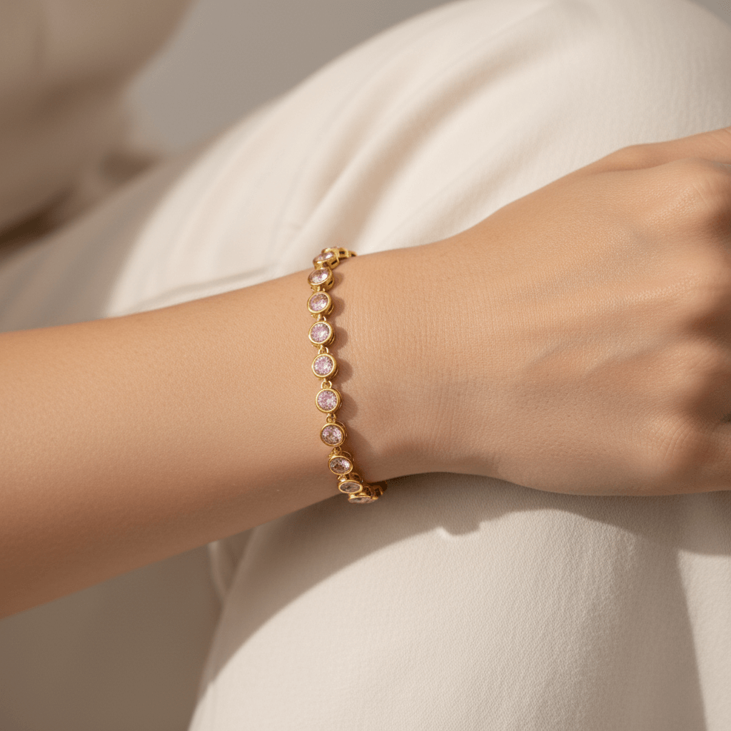 Model wearing the Sweetheart Pink Crystal Tennis Bracelet stacked with a gold watch.