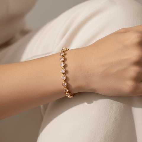 Model wearing the Sweetheart Pink Crystal Tennis Bracelet stacked with a gold watch.