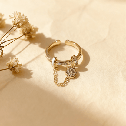 A detailed shot focusing on the main band of The Comet Ring. The image clearly shows the glossy, white enamel accent on one side and the row of channel-set crystals on the other, highlighting the ring's mixed-media design.