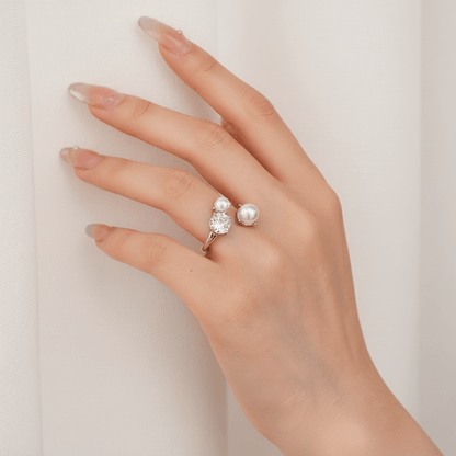 A model's hand, adorned with The Celestial Ring, holding a handwritten card with calligraphy. This romantic scene positions the ring as the perfect gift for an anniversary, engagement, or a declaration of love.