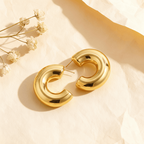 Close-up of the gold Cloud Hoops, showing their puffy, dome-like shape, hollow construction, and high-polish finish.