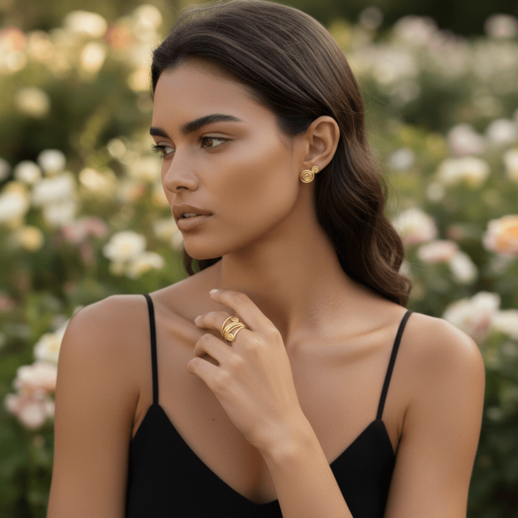 A close-up of a model's hand, wearing The Oracle Ring, gently brushing against a rich, navy velvet fabric. The tactile contrast between the cool, smooth metal and the soft, plush textile highlights the ring's luxurious quality.