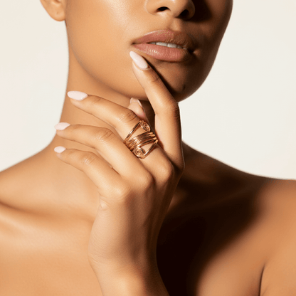 A powerful shot of a model's hands clasped together, with The Oracle Ring prominently featured. Her confident posture and the ring's armor-like presence combine to create an image of undeniable self-assurance.