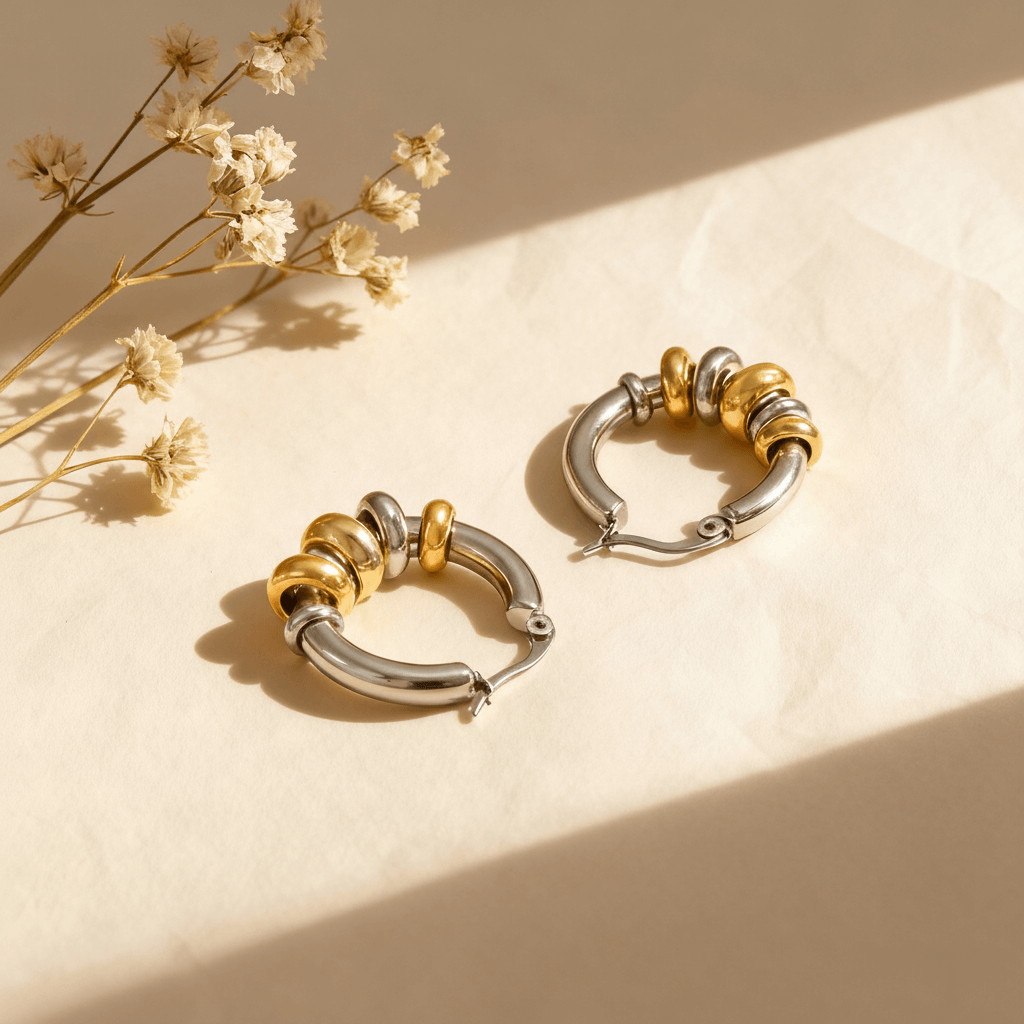 A pair of two-tone Siena Stacked Hoops, highlighting the textural, multi-ring design and high-shine 18K gold-painted and polished finish.
