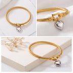 Collage of gold cable bangle details showing U-hook clasp and silver heart charm.