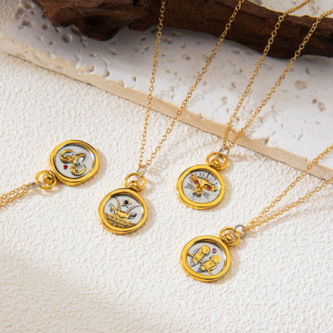 Aesthetic flat lay of mixed metal horoscope coin necklaces on textured stone background.