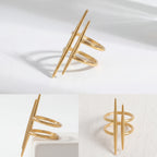 Aesthetic product photography details of gold double bar ring architectural design on white stone.