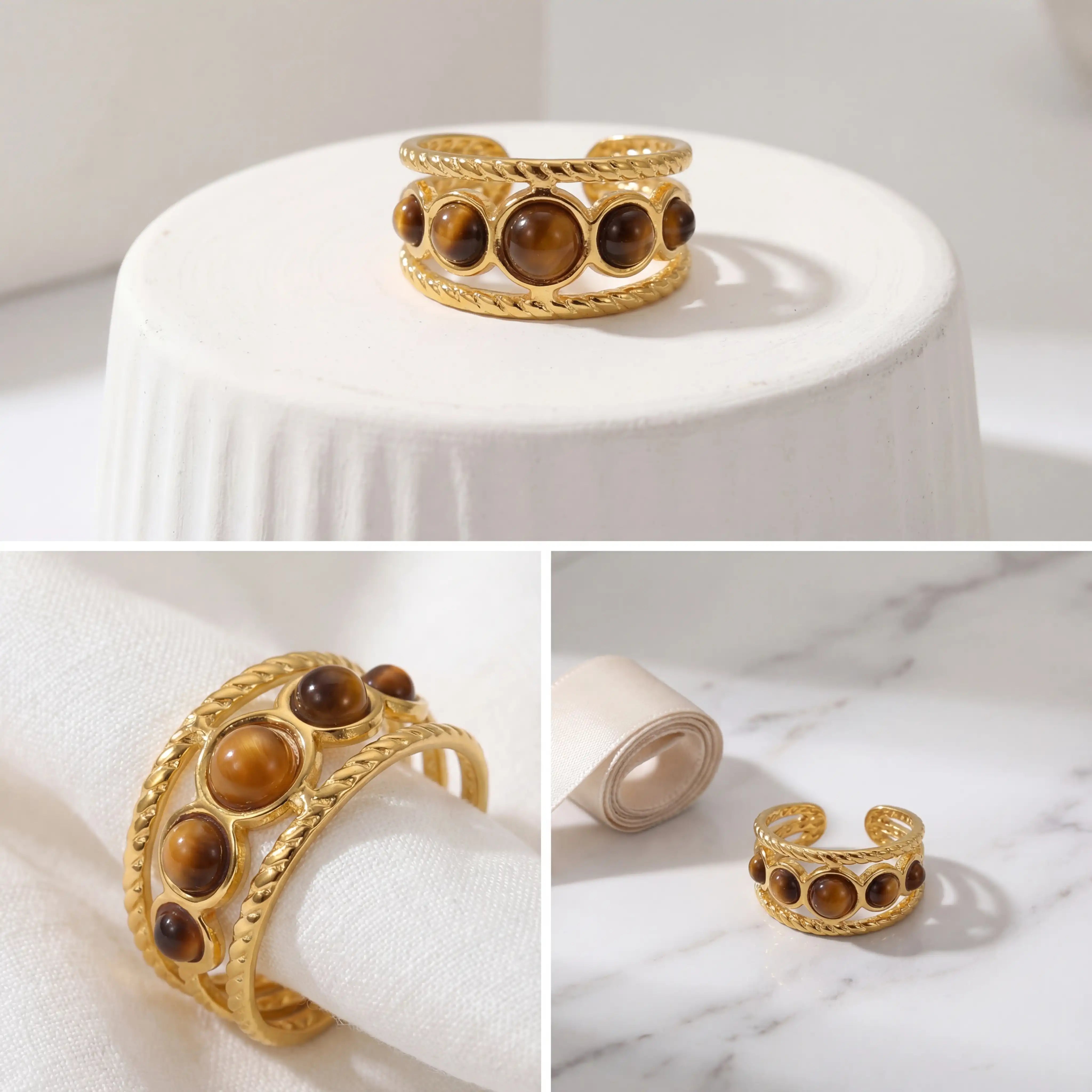 Aesthetic product photography of vintage gold gemstone ring on white pedestal.