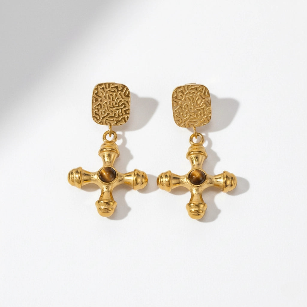 Pair of byzantine style gold cross earrings with amber brown center stone.