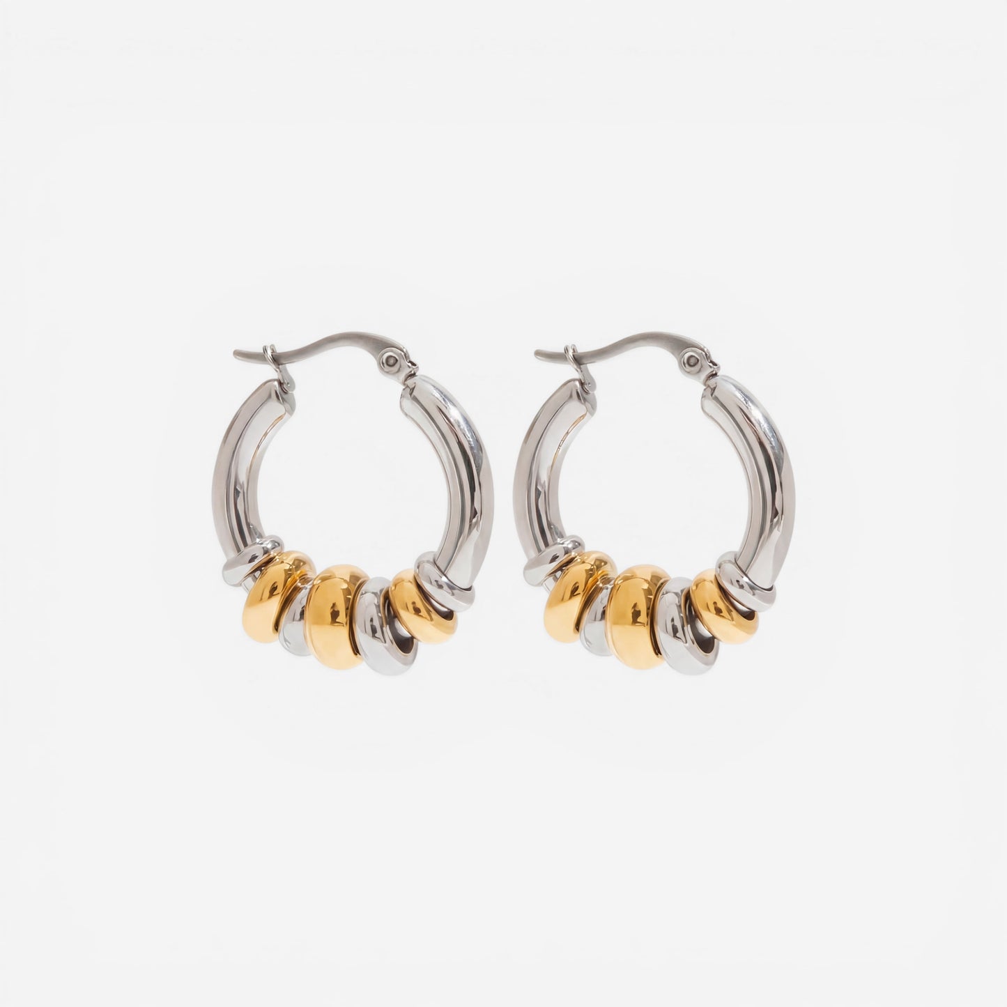 Mixed metal two-tone gold and silver stacked hoop earrings waterproof jewelry.
