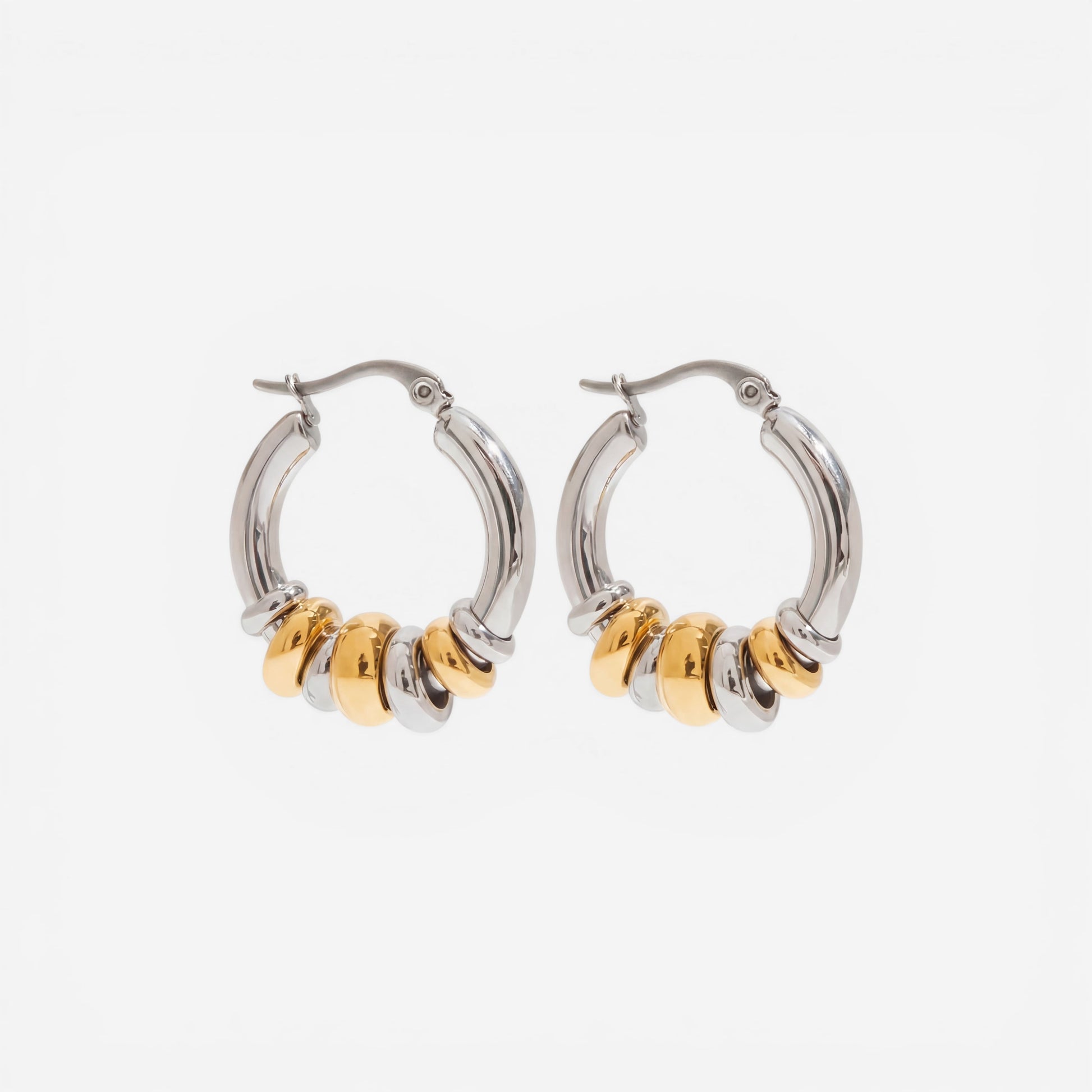 Mixed metal two-tone gold and silver stacked hoop earrings waterproof jewelry.
