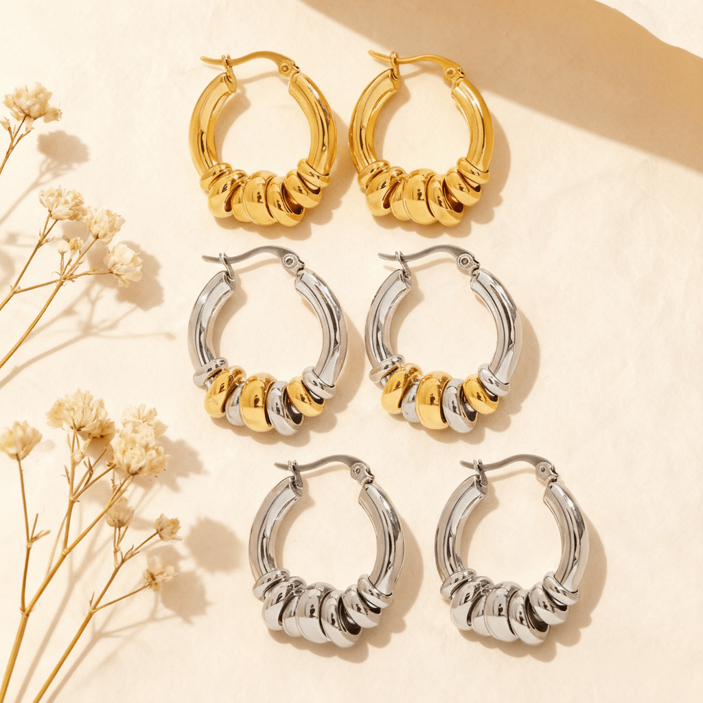 Three pairs of the Siena Stacked Hoops in 18K gold, polished silver, and a two-tone mixed metal finish, displayed together on a white background.