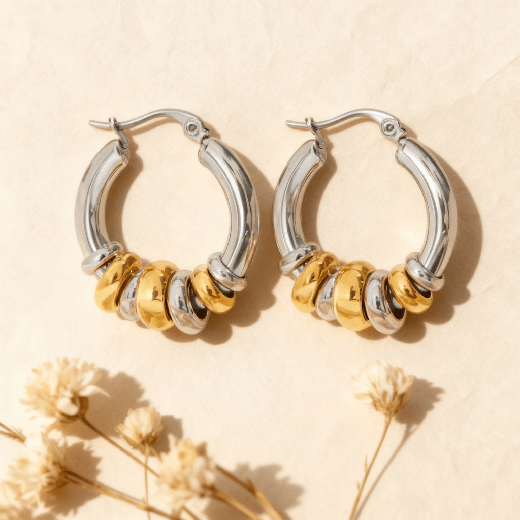 A pair of two tone Siena Stacked Hoops, highlighting the textural, multi-ring design and high-shine 18K gold-painted and polished finish.