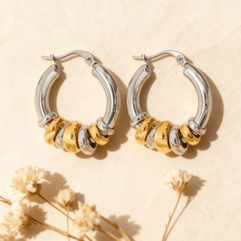 A pair of two tone Siena Stacked Hoops, highlighting the textural, multi-ring design and high-shine 18K gold-painted and polished finish.