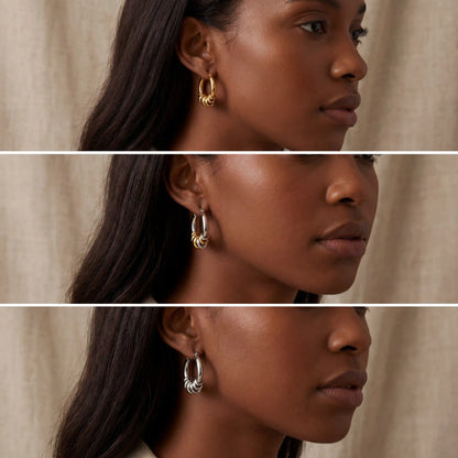 Model with dark skin wearing silver and gold chunky stacked earrings everyday look.
