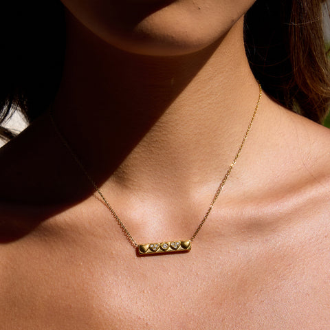 Heartline Bar Necklace — gold bar pendant with heart details and stones, romantic and elegant necklace.