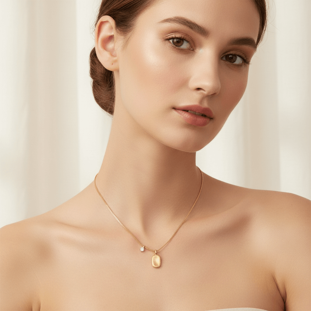 A model wearing an elegant black silk slip dress, with the dainty Signature Necklace as her sole piece of jewelry. The shot demonstrates how the necklace's minimalist design can provide a perfect, sophisticated finishing touch for a formal look