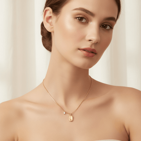 A model wearing an elegant black silk slip dress, with the dainty Signature Necklace as her sole piece of jewelry. The shot demonstrates how the necklace's minimalist design can provide a perfect, sophisticated finishing touch for a formal look