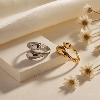 Fluid Pebble Ring — sculptural adjustable pebble wrap ring in gold/silver finish, waterproof and safe for sensitive skin.