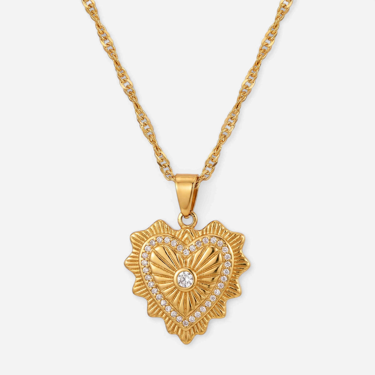 Gold heart shaped pendant necklace with vintage etching and crystal detail waterproof stainless steel.
