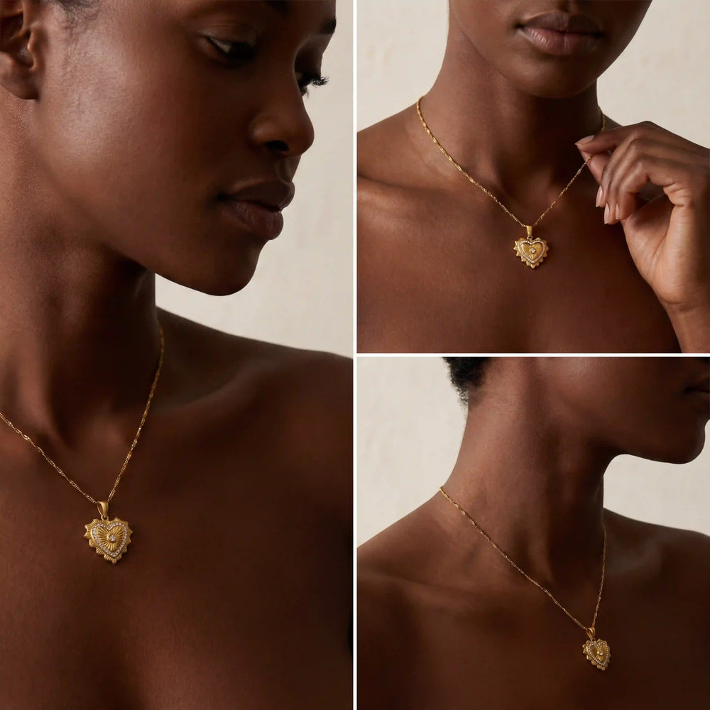 Model with dark skin styling romantic gold heart necklace vintage aesthetic.