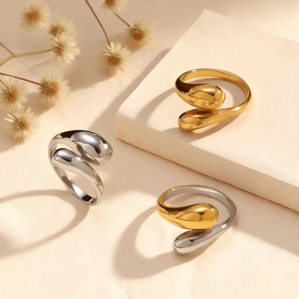 The all-gold and all-silver Fluid Pebble Rings styled together to show the different color options available for this modern, sculptural piece.