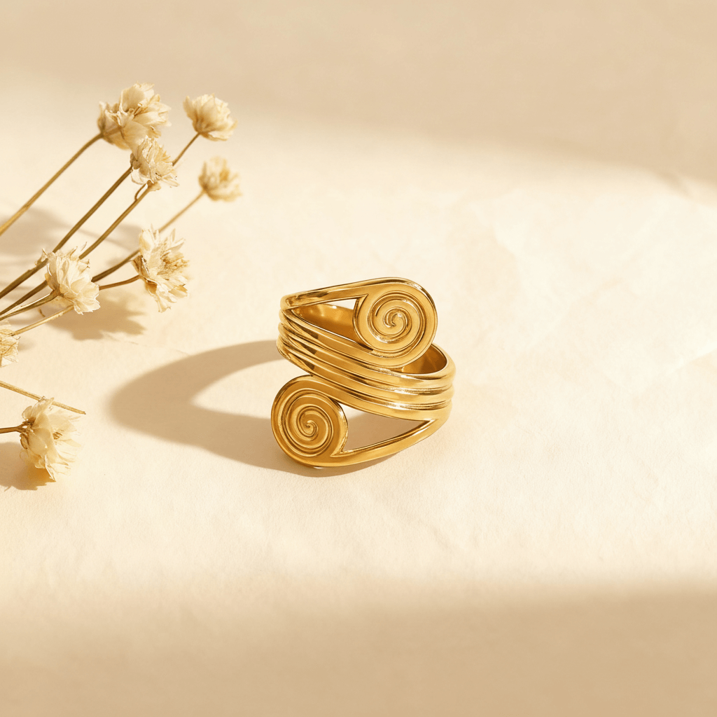 The Oracle Ring in 18k gold plate, a wide, adjustable cuff ring with a double spiral design. The image includes annotations for its dimensions, 4.5g weight, and materials (Waterproof, Hypoallergenic Stainless Steel).