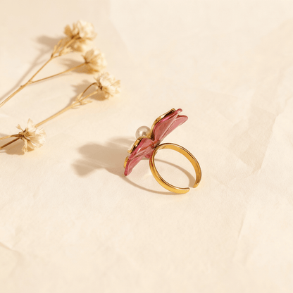 An extreme close-up on the edge of a petal of The Orchid Ring, focusing on the glossy, fuchsia-pink enamel. The image clearly shows how the enamel follows the curve of the gold petal, highlighting the artisanal, hand-painted quality.