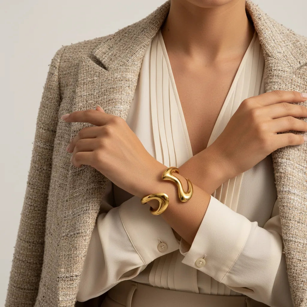 A close-up of a model's hands crossed, with The Pythia Cuff featured prominently, embodying a sense of confidence and modern elegance.