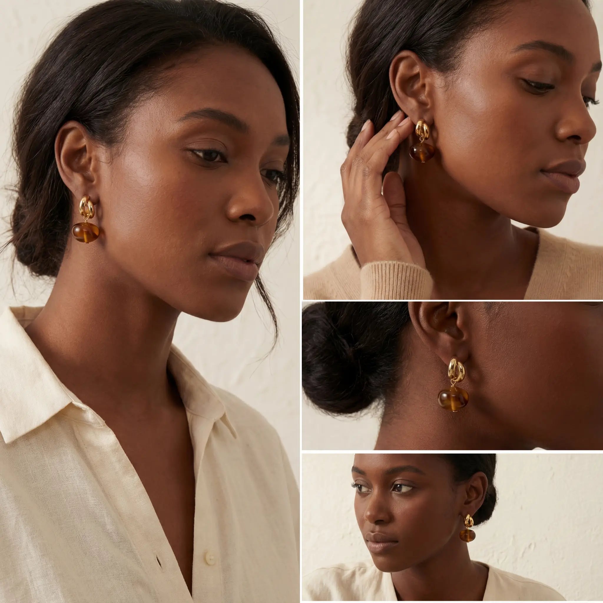 Model with dark skin styling gold and amber drop earrings office wear jewelry.