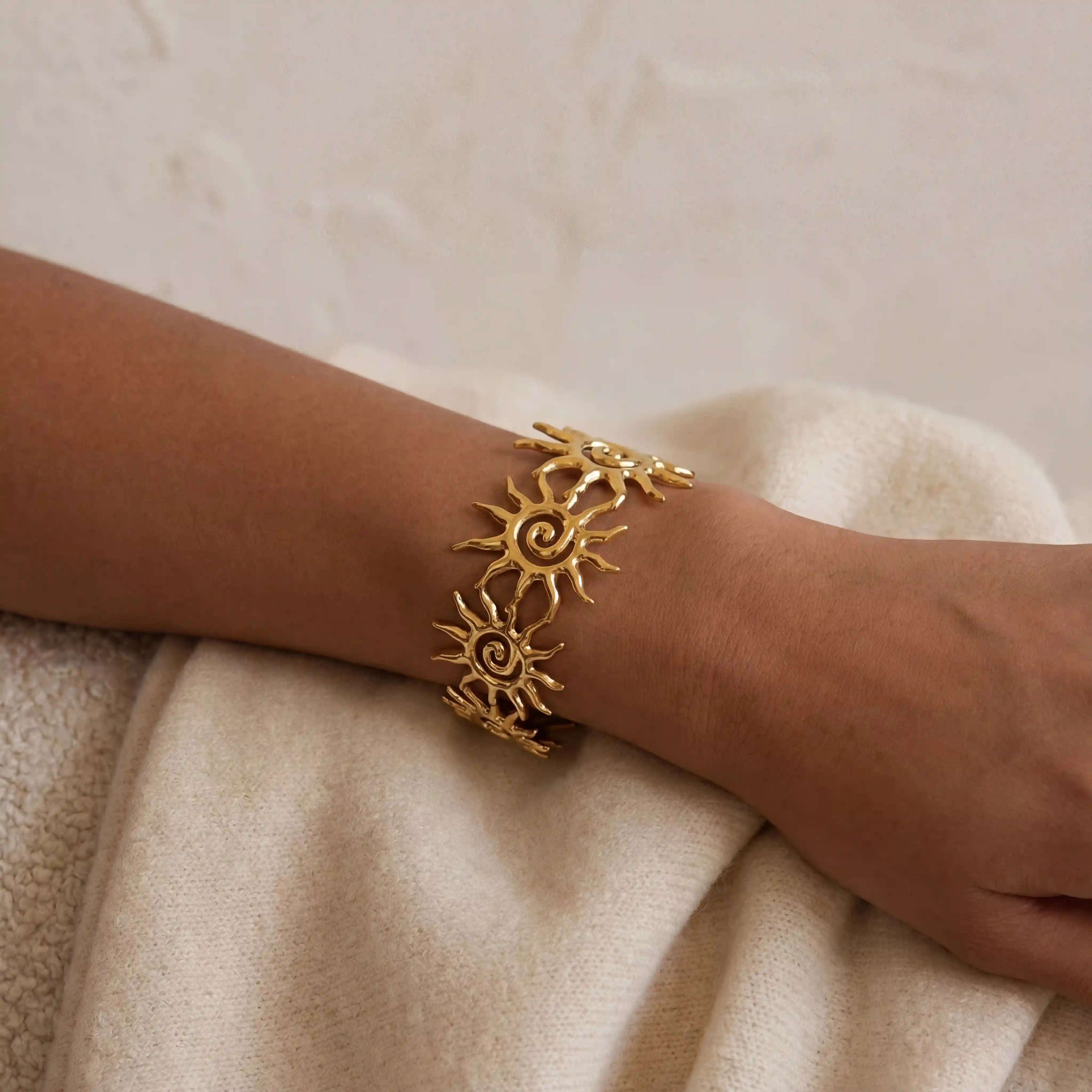 Collage of different angles of adjustable gold sun cuff bracelet waterproof jewelry. Main image