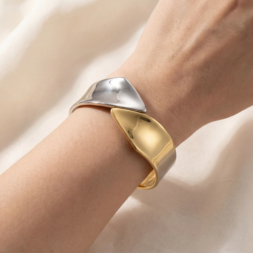 Close up of architectural two-tone hinge cuff bracelet mixed metal gold and silver style.