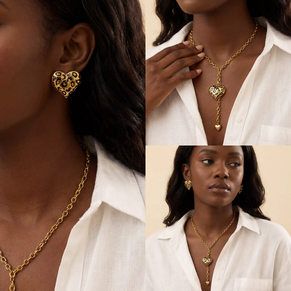 Model with dark skin wearing gold leopard heart earrings and matching lariat necklace set.