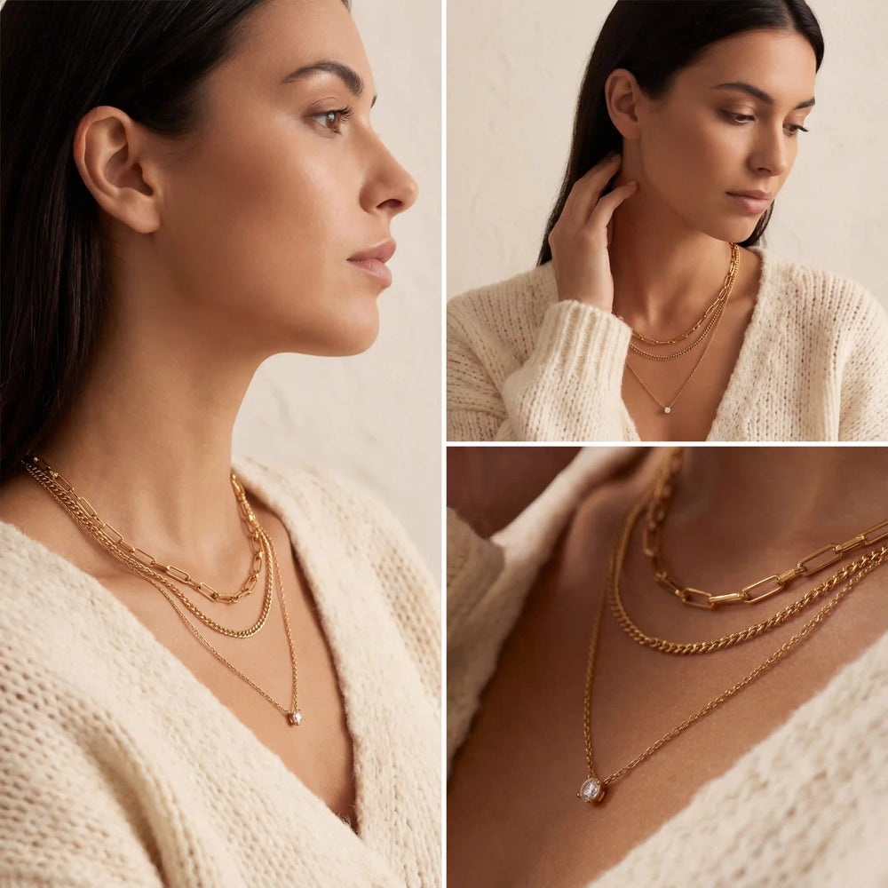 A model wearing The Charites Necklace, demonstrating how the triple-strand design elegantly fills the neckline of a simple top.